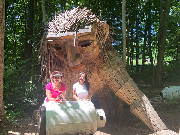 Kathy Hagerty and Carmen Ford with sculpture