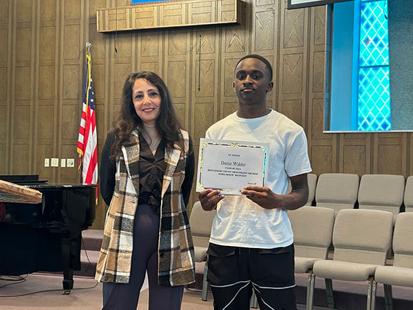 Damir Walter holding a certificate standing next to mentor.