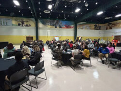 Students and families seated at tables