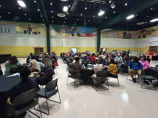 Students and families seated at tables